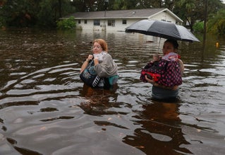 two women walking through floods