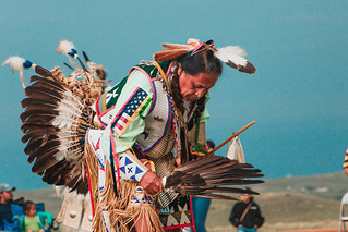 Native American man performing at pow wow
