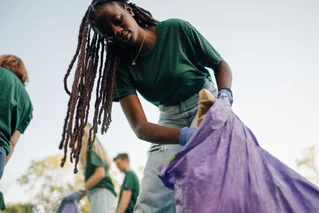 woman picking up trash