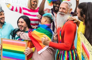 A group of people celebrating Pride Month with rainbow attire