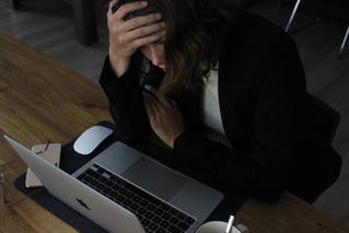 stressed woman looking at computer