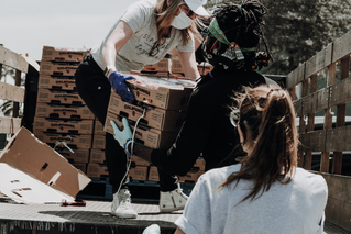 volunteers moving supplies off a truck