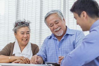 elderly couple meeting with a financial advisor