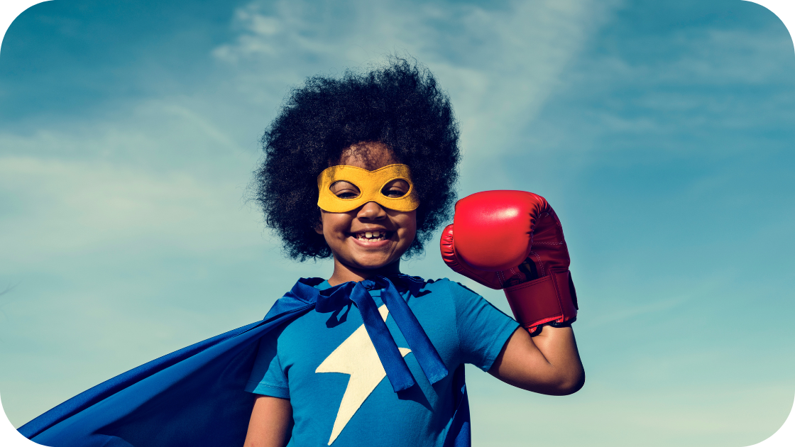Child dressed in a superhero costume, smiling