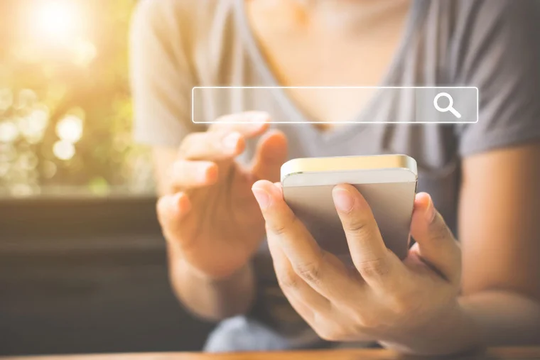 woman holding phone with search overlay