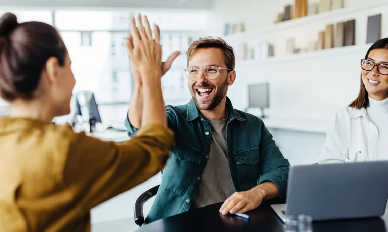 man and woman high fiving