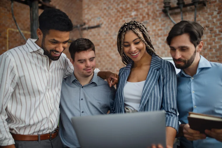 Group of friends looking at an open laptop