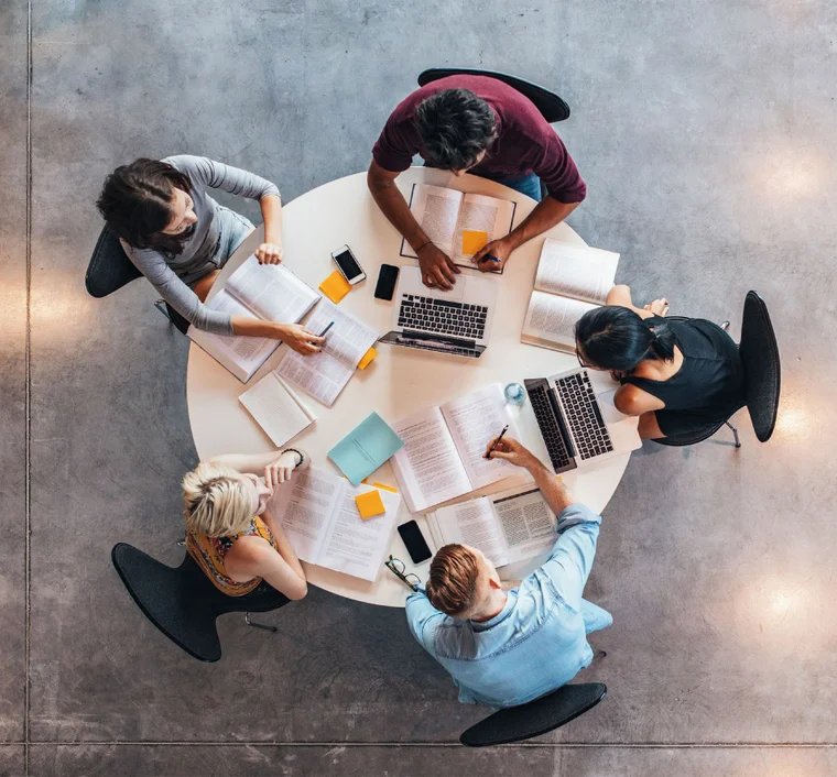 Bird's eye view of a group of professionals working at a round table
