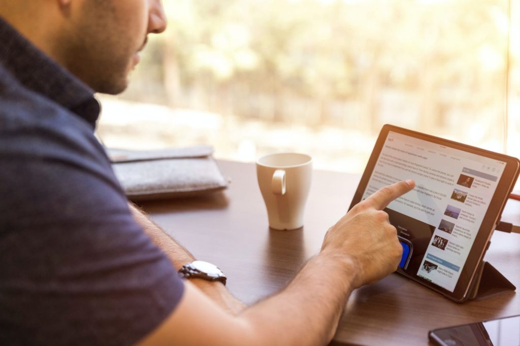 Man searching online on his tablet