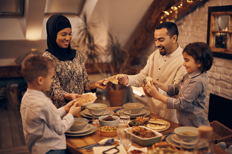 A muslim family smiles while celebrating Ramadan