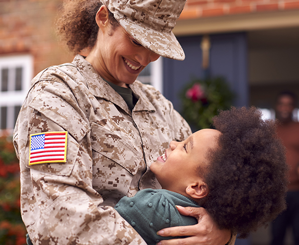 American Female Soldier In Uniform Returning Home To Family On Leave